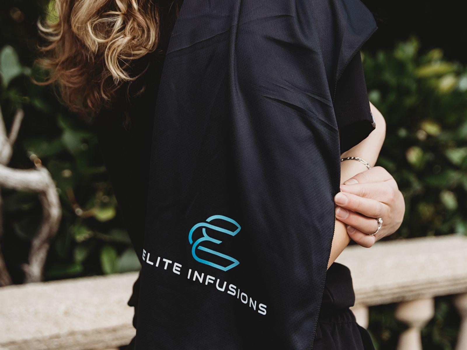 An Elite Infusions tote bag on a member's shoulder